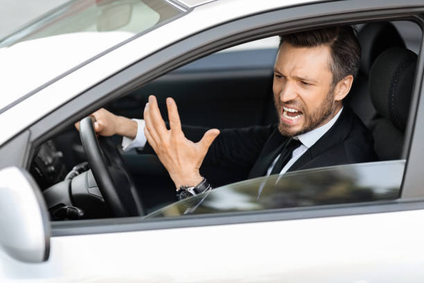 istock Expressive middle-aged businessman screaming while driving car 1322842964