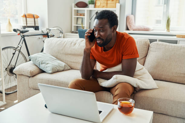 istock Handsome young African man talking on the phone and smiling 1322843779