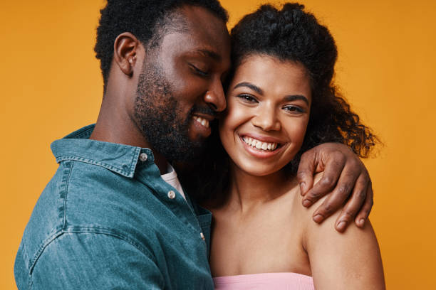 istock Beautiful young African couple hugging and smiling 1322844058