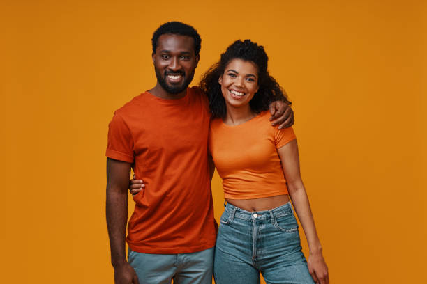 istock Beautiful young African couple looking at camera and smiling 1322844291