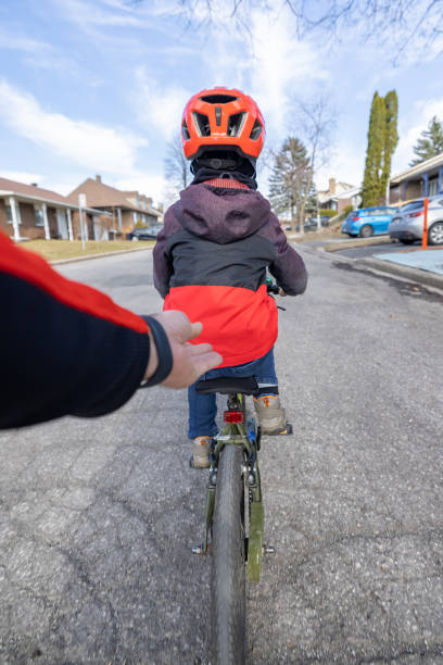istock POV Father Helping his Son Riding his Bicycle Without Training Wheels 1322844368