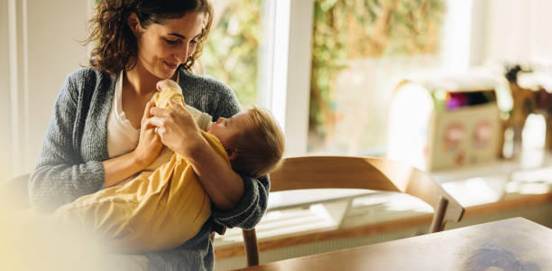 istock Loving mother feeding baby son with bottle 1322845317