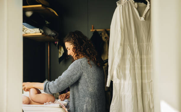 istock Mother changing baby diaper 1322845392