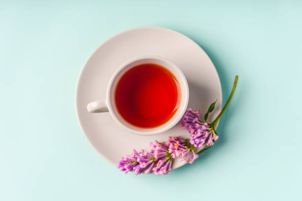 istock Beautiful minimalist background with floral composition and tea mug, copy space on light blue backround 1322845471