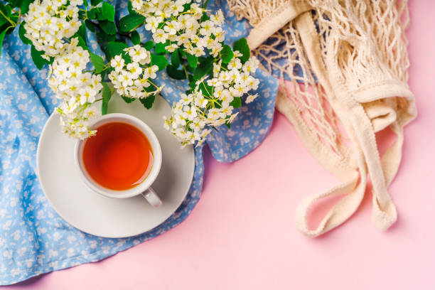 istock Beautiful minimalist background with floral composition and tea mug, copy space on light blue backround 1322845522