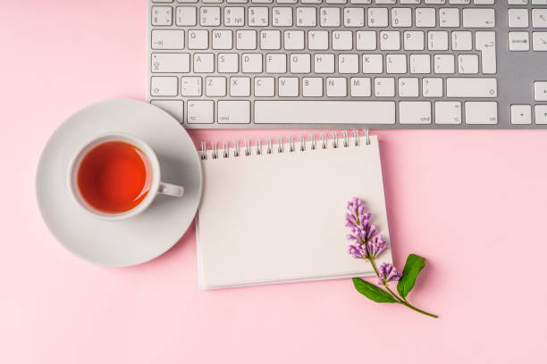 istock A workspace with note paper and a floral composition. Beautiful spring background with space for text, top view 1322846068