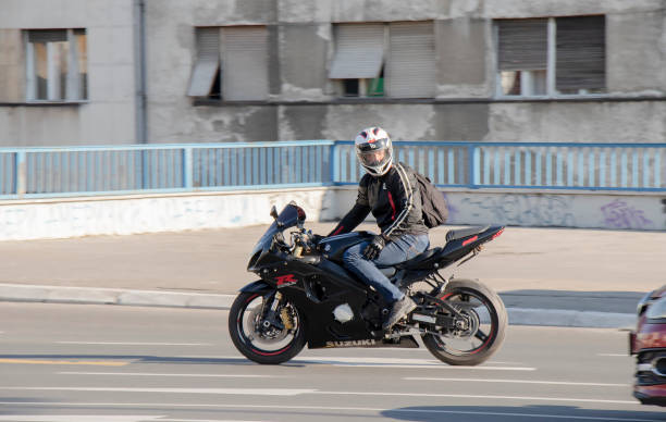 He went to motorcycle trip alone at the last sunny day of summer. He came one of the forest and he hold his motorcycle on forest's road to forest and then he preferred  to eating or drinking harmful beverage products to reading book.