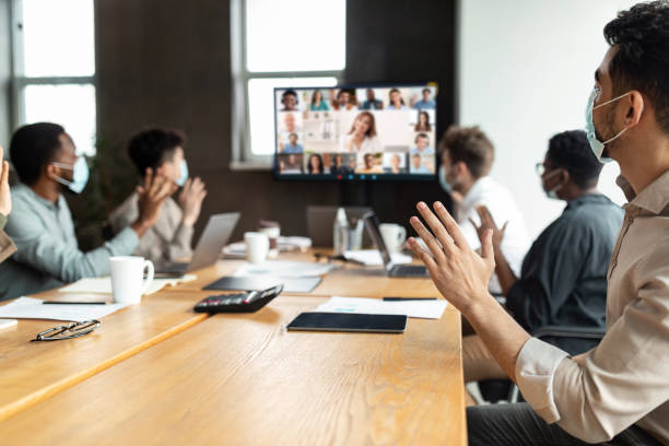 Diverse businesspeople making online video call to employees