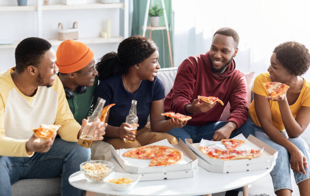 istock Joyfull african american millennial friends eating pizza 1322848208