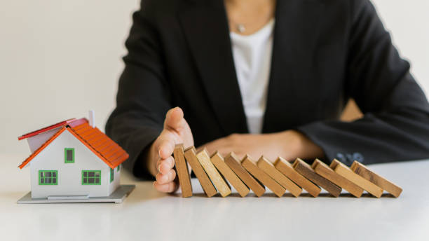 istock risk control concept A businessman defends a falling wooden block and a construction business risk strategy to select and protect the wooden blocks that line up on the table. 1322848483
