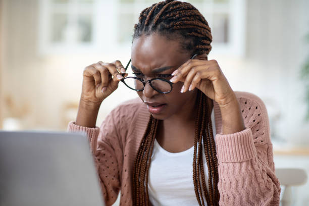 istock Eyesight Problems. Black Lady In Glasses Squinting While Looking At Laptop Screen 1322848851