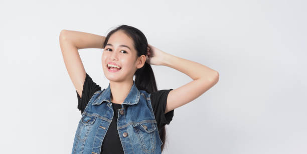 istock Asian Young woman gesture posing on white background. represent cheerful and confident. Showing gestures such as mini heart Okay Thumb up or point out. Happy amazed excited and surprised Jacket jeans. 1322848857