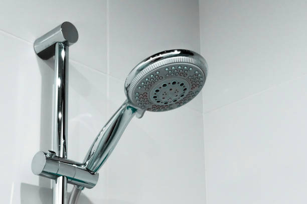 istock Shower head with water drops close up in the bathroom 1322849546