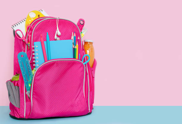 istock Pink backpack with school supplies 1322849561