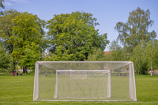 Soccer goals in a park called Fælledparken, which is a very large and popular park in the center of Copenhagen. The soccer goals are placed at the side of the soccer fields and the players can choose the size which fits them
