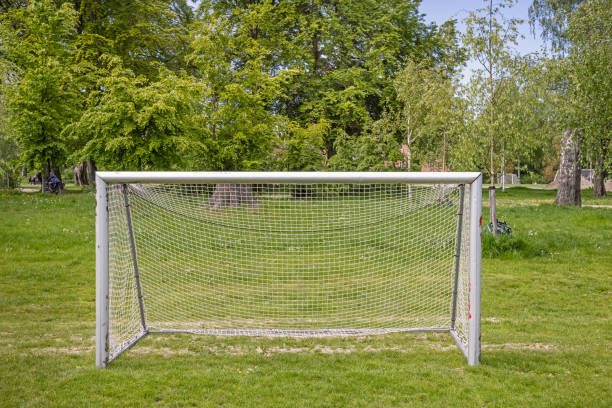 Soccer goals in a park called Fælledparken, which is a very large and popular park in the center of Copenhagen. The soccer goals are placed at the side of the soccer fields and the players can choose the size which fits them