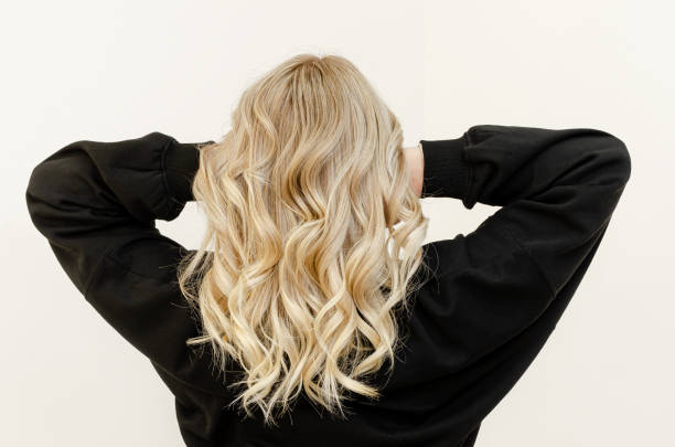 Wavy hair look from behind Modern trendy Air Touch Ombre technique for hair dyeing. Look from behind blond hair stock pictures, royalty-free photos & images