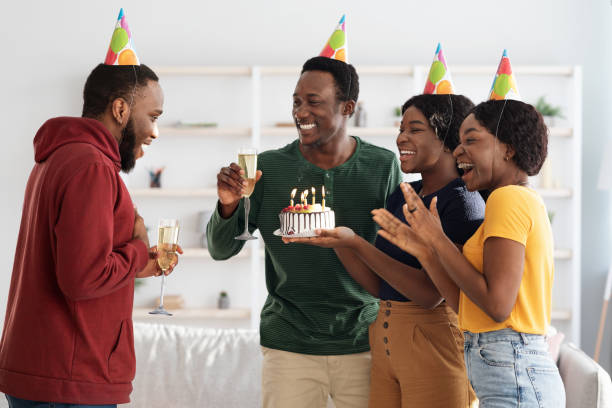 istock Happy black friends making surprise for birthday guy 1322849819