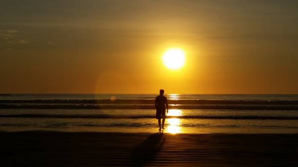 istock Man on the beach at the sunshine 1322849904