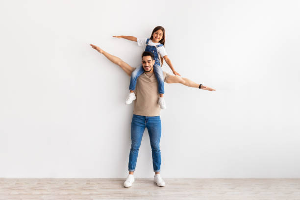 istock Cheerful Man Riding Excited Daughter On His Shoulders 1322850253