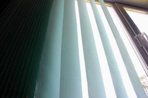 istock Closed vertical blinds against the background of the window. 1322851412