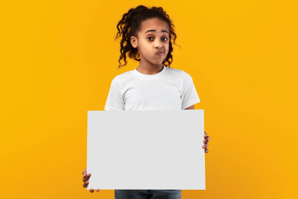 istock Black girl holding blank white advertising billboard at studio 1322851484