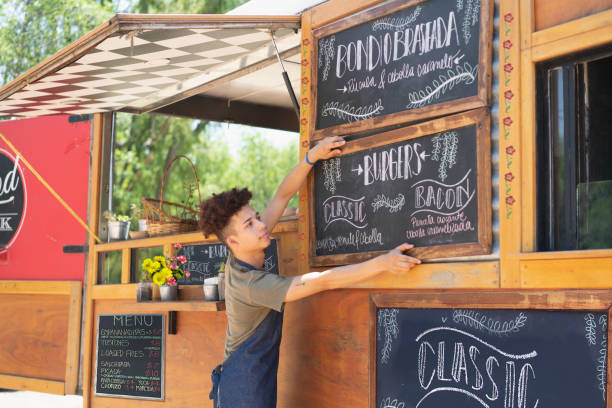 Young man working in a food truck
