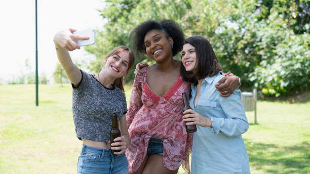 istock Friends having fun outside at the park and taking selfies 1322851544