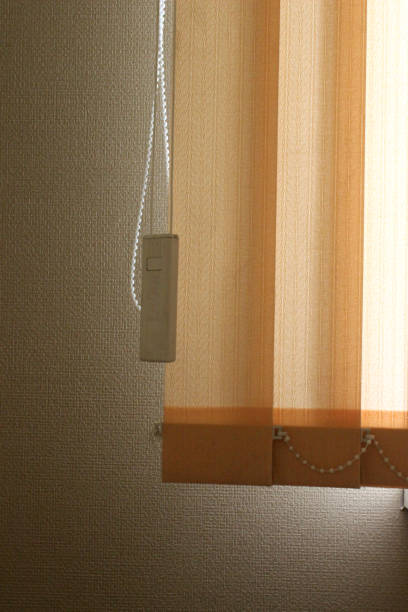 istock Closed vertical blinds against the background of the window. 1322851559