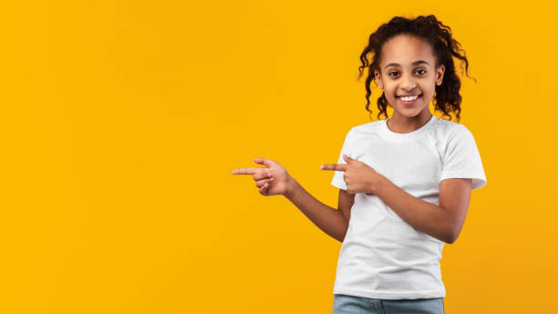 istock Smiling black girl pointing aside at free copy space 1322851749