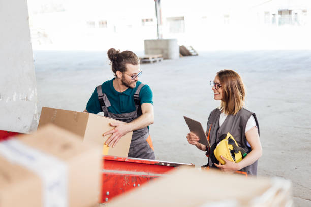 istock Young woman working on a quality control with her worker at the warehouse 1322853155