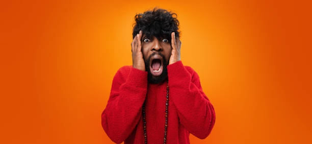 istock Young thrilled casual black man screaming on yellow background 1322853170