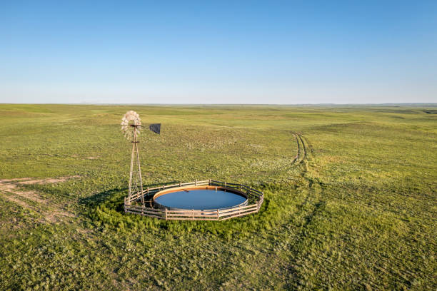 windmill with water tank in colorado prairie - water pumping windmill imagens e fotografias de stock