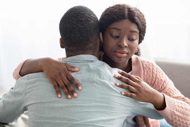 istock Dishonest black lady hugging her boyfriend or husband 1322856552