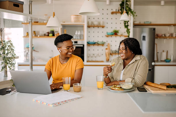 istock Two smiling woman working from their home office setup 1322857213