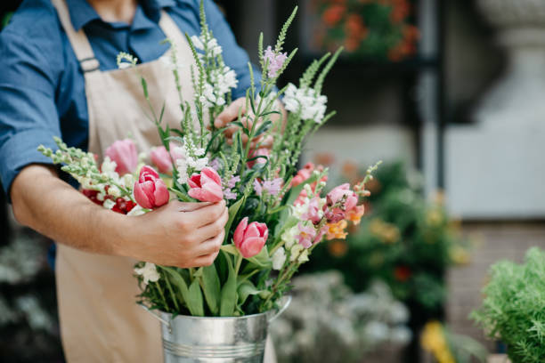 istock Designer work with plants, modern composition. Flower shop owner and small business 1322857332