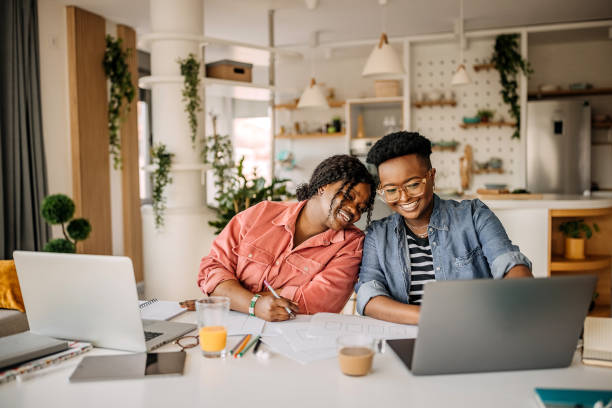 istock Two smiling woman working from their home office setup 1322857528