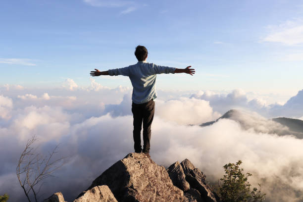 istock Asian man standing on the hilltop. 1322858613