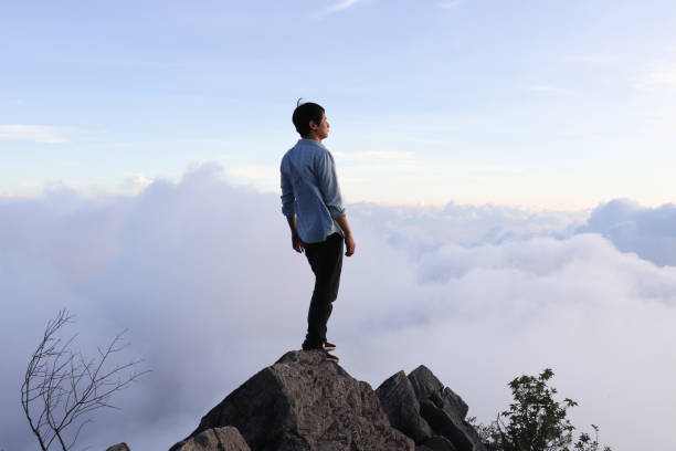 Asian man standing on the hilltop. Asian man standing on the hilltop. Distant stock pictures, royalty-free photos & images