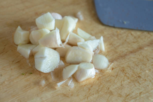 istock minced garlic by knife on wooden board 1322859385