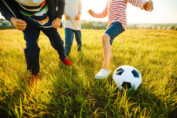 istock School-age boys play soccer during the summer holidays. 1322860413