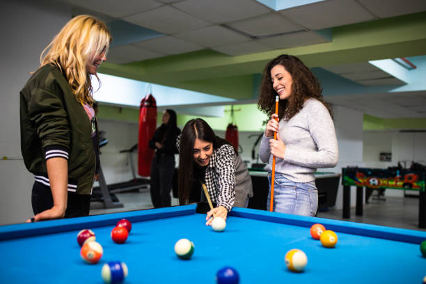 istock Friends enjoying a game of pool 1322862056