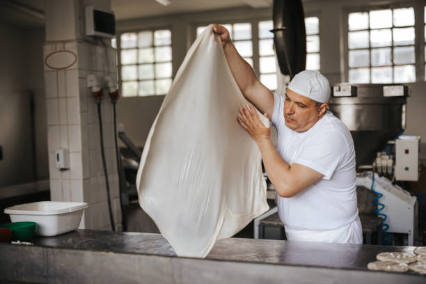 istock Chef spinning dough in the professional kitchen at Bakery 1322862189
