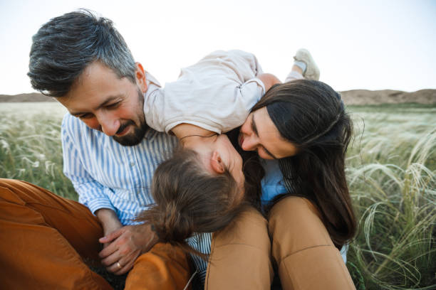 istock A hipster family walks in a summer field. 1322862403