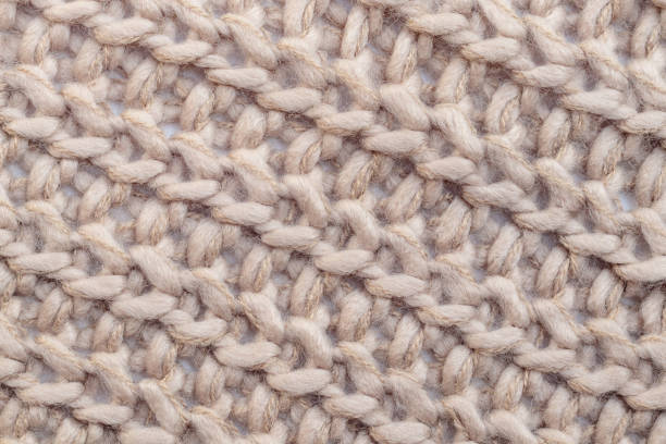 istock Close up of beige woolen knitted scraf. 1322865968