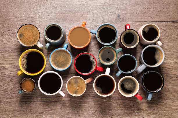 istock Cups of hot coffee on wooden table, flat lay 1322870191