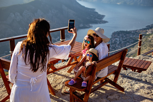 Girl with mother and grandmother doing selfie on top of Kotor Bay - Montenegro View