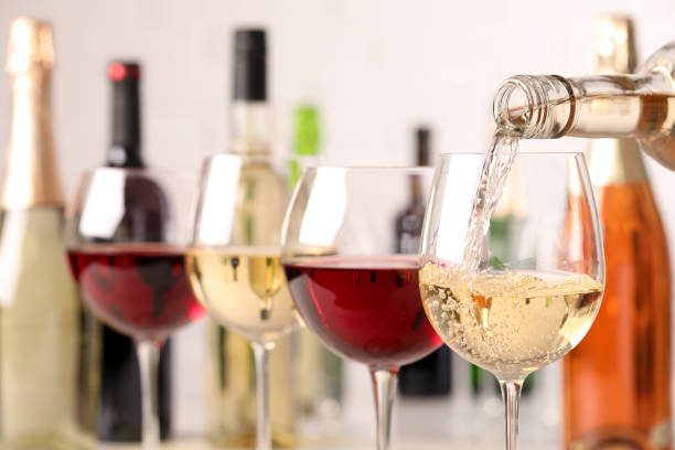 istock Pouring white wine from bottle into glass, closeup 1322871356
