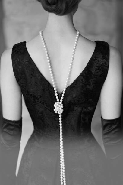 beautiful woman figure in a black dress and pearls. book cover design. black and white photo. - real people caucasian one person black and white imagens e fotografias de stock