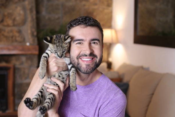 istock Cute guy and stunning hybrid cat 1322873143